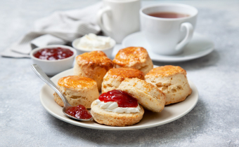 Scones,On,A,White,Plate,,A,Jar,Of,Strawberry,Jam