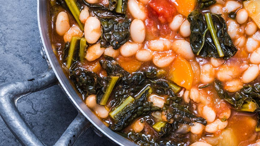 Soup with vegetables, beans, kale, top view.Typical tuscan soup, ribollita.