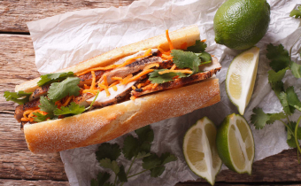 Vietnamese Pork Banh Mi Sandwich with Cilantro and carrot close-up on the table. horizontal view from above