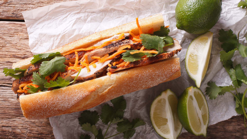 Vietnamese Pork Banh Mi Sandwich with Cilantro and carrot close-up on the table. horizontal view from above